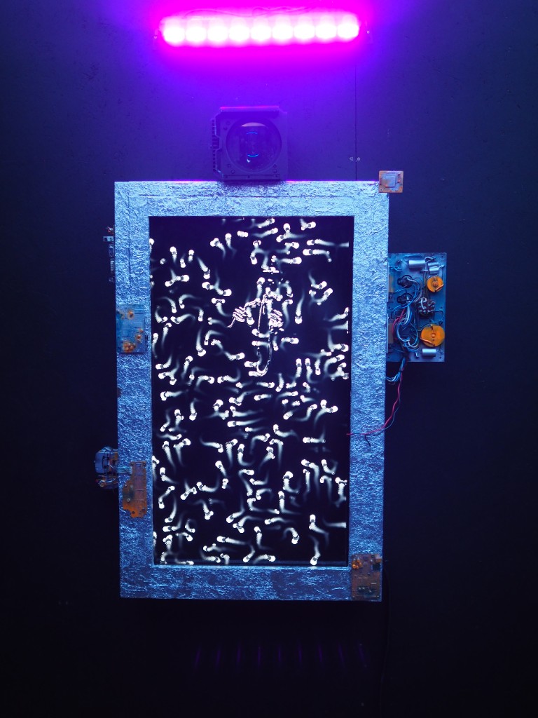 Interactive light art: silver frame, neon bar, and glowing projected forms
